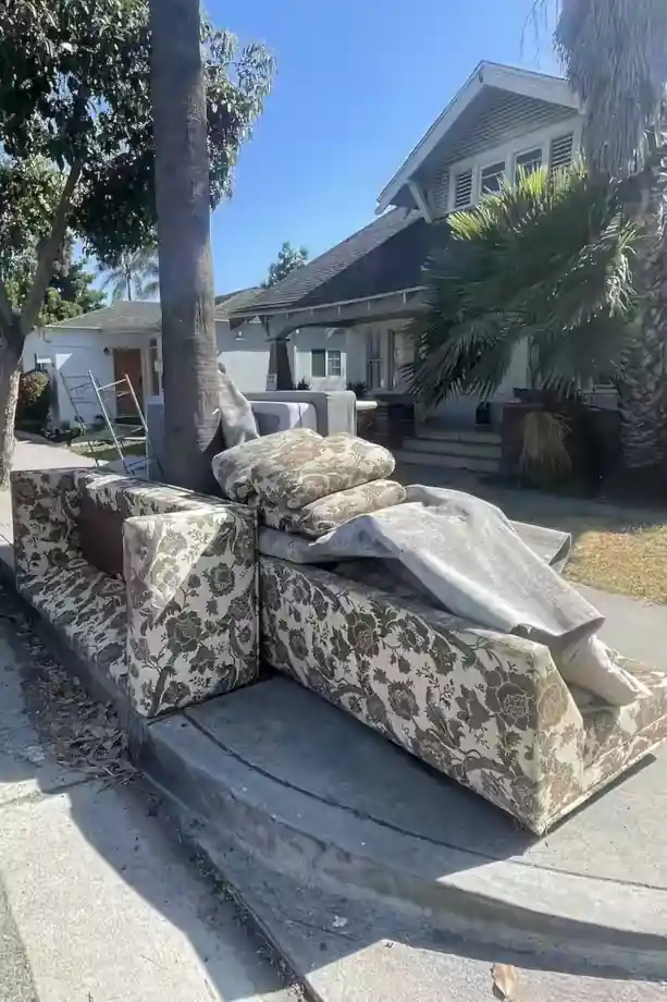 Old sectional sofa and furniture removed during curbside Orange County junk removal by The OC Bros.