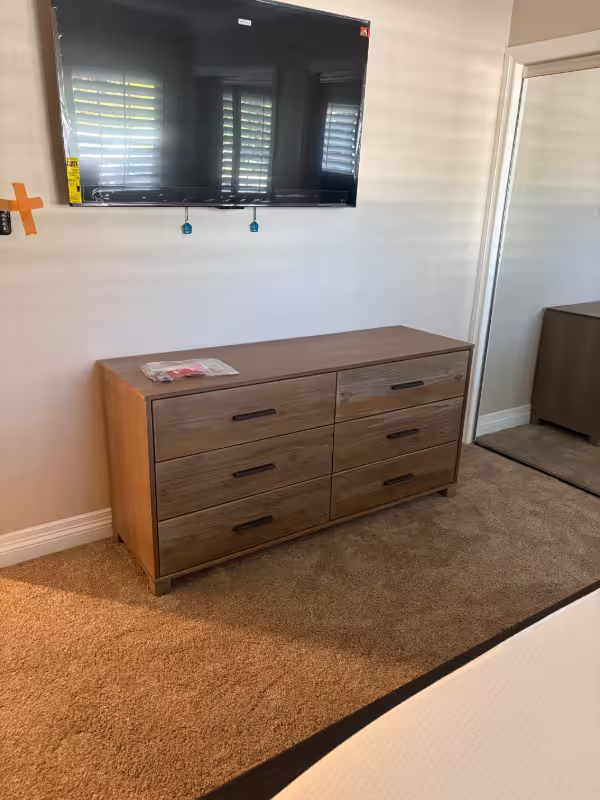 Anaheim furniture assembly service completing a 6-drawer dresser installation in a bedroom.