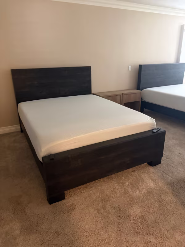 Anaheim furniture assembly technicians installed two queen bed frames with matching nightstands in a rental property.