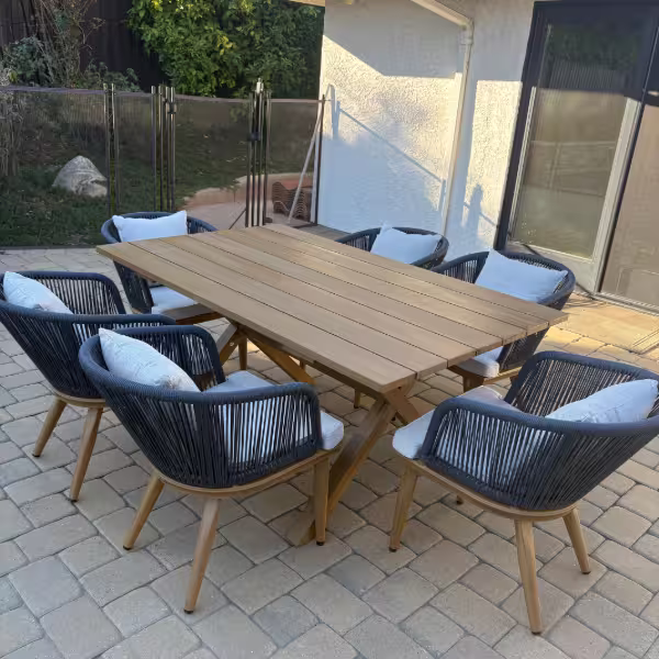 Anaheim furniture assembly service — outdoor patio dining table with six chairs assembled and placed on a stone patio.