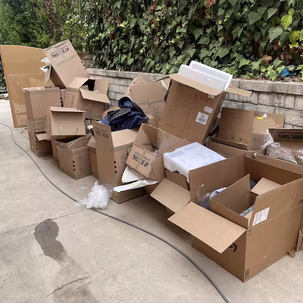 Piled cardboard boxes and packing materials ready for junk removal and recycling.