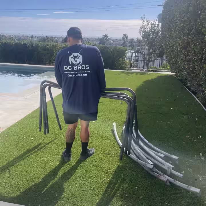 OC Bros junk removal crew working in Newport Heights backyard